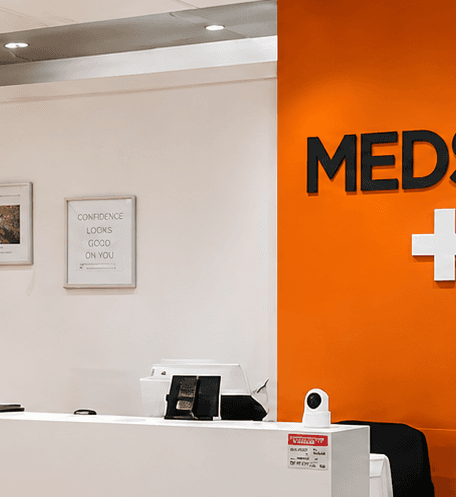 The orange MEDSPA feature wall with the wordmark and medical cross