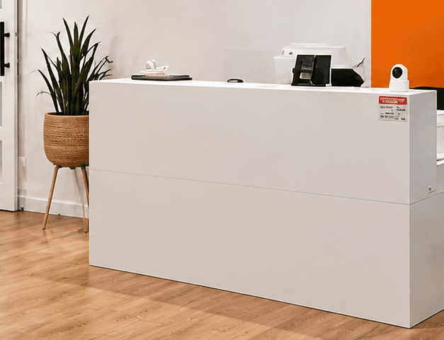 The white reception desk in the MEDSPA lobby